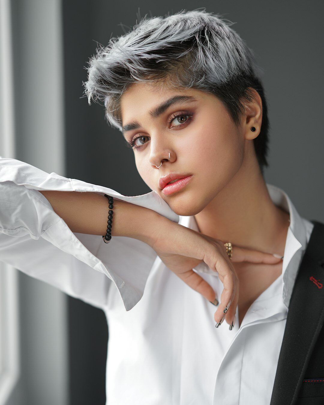Studio portrait of an older Latin American woman with short grey hair