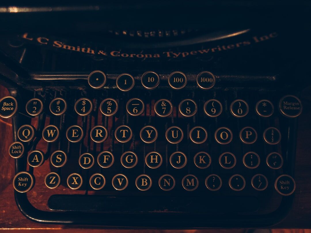 Vintage typewriter with a blank sheet of paper on a wooden desk