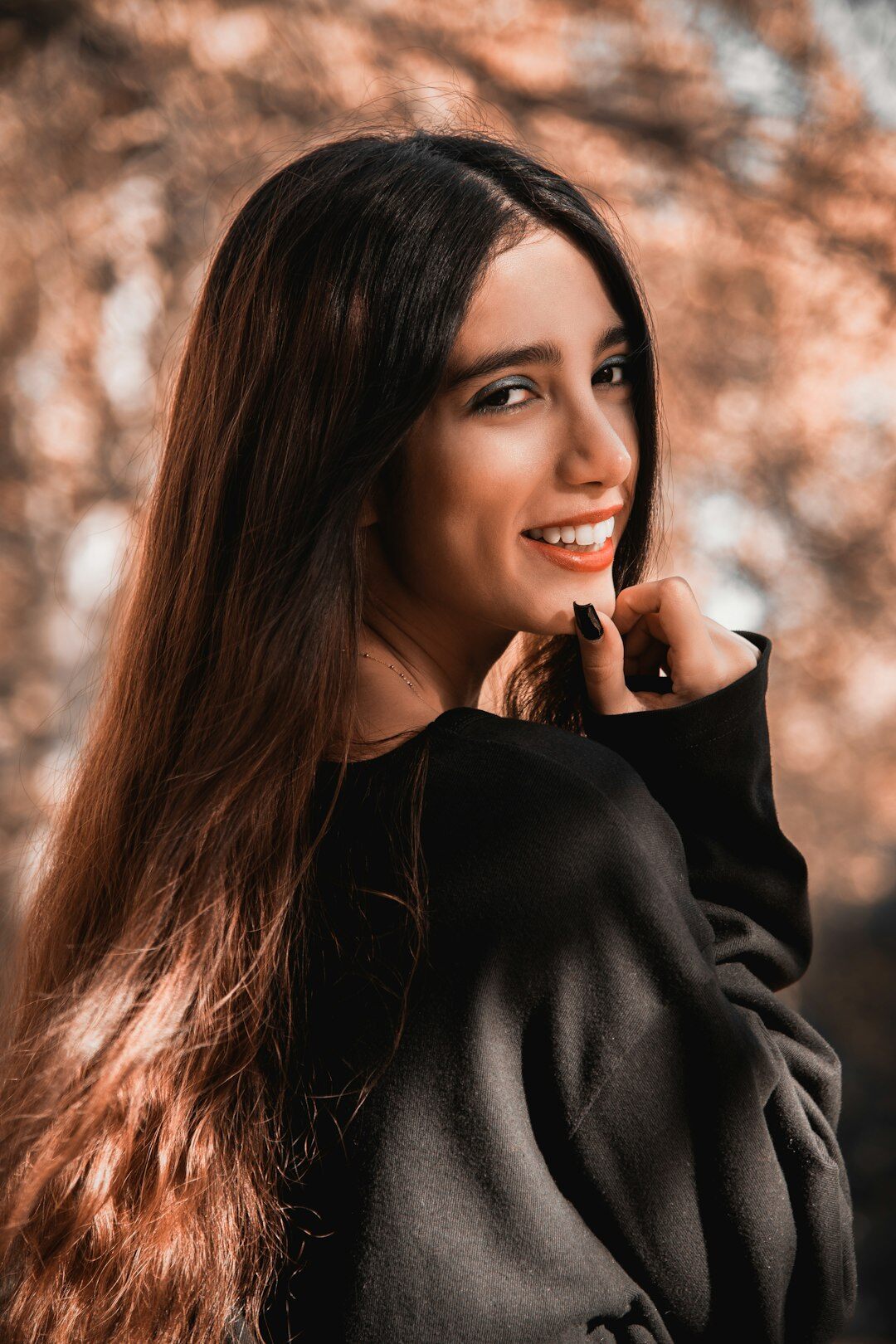 Studio portrait of a young Latin American woman smiling softly