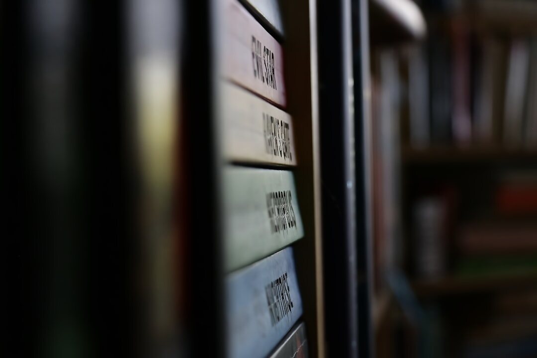 Rows of colorful hardcover books stacked on wooden shelves